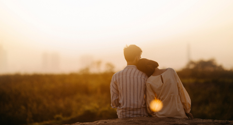 Couple embracing watching a sunset
