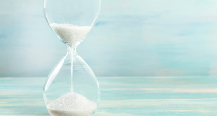An hourglass with a blue background