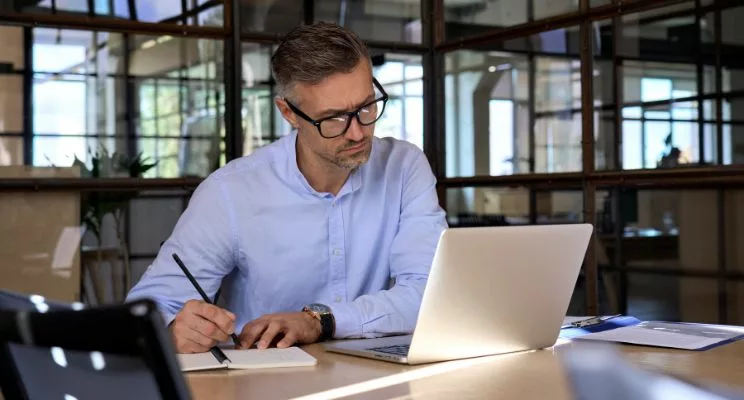 mature business man executive manager looking at laptop